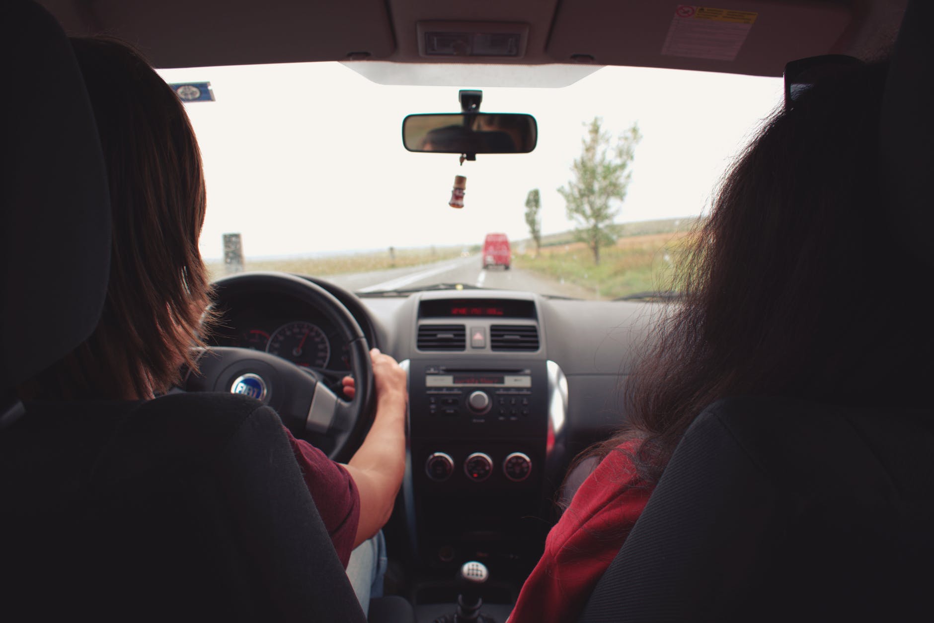 two woman sitting inside vehicle